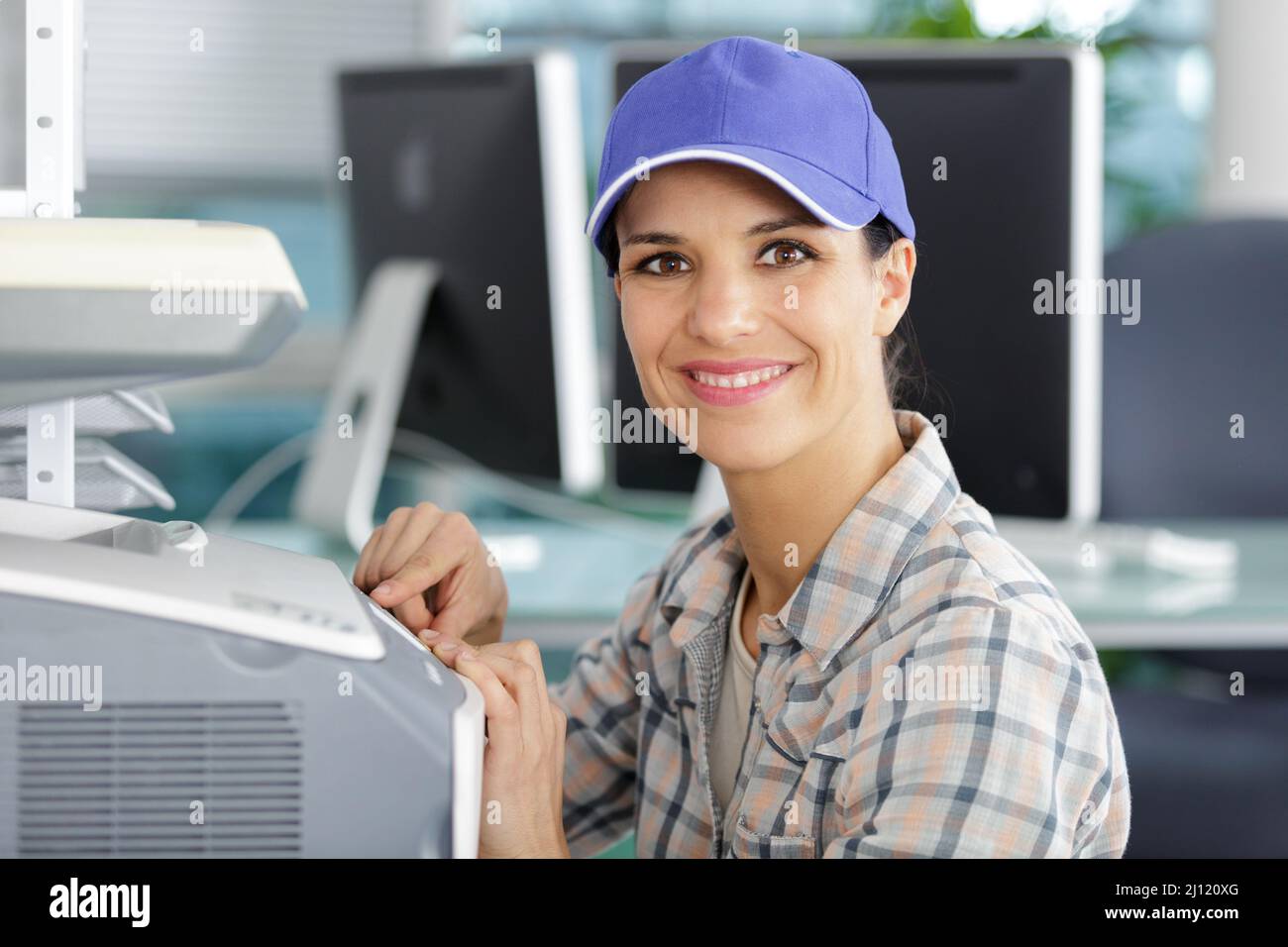 young female technician fixing a printer Stock Photo