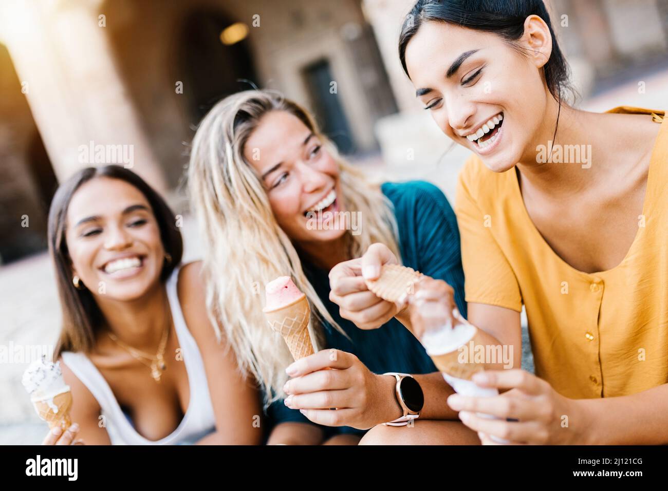 Happy multiethnic women laughing together outdoors Stock Photo
