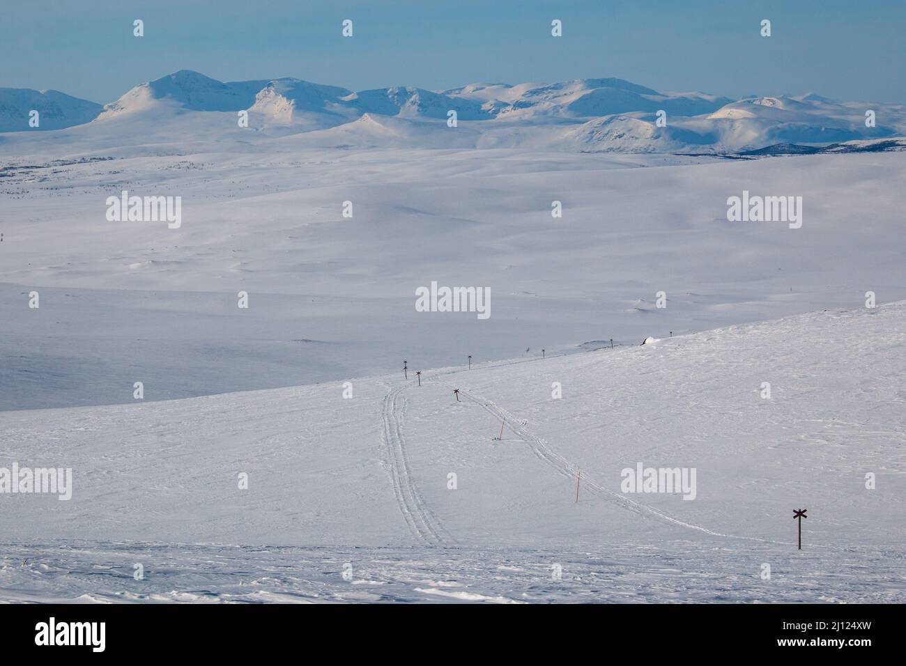 A winter skiing and snowmobile track towards Ammarnas from Serve hut. A part of Kungsleden trail, March, Lapland, Sweden. Stock Photo
