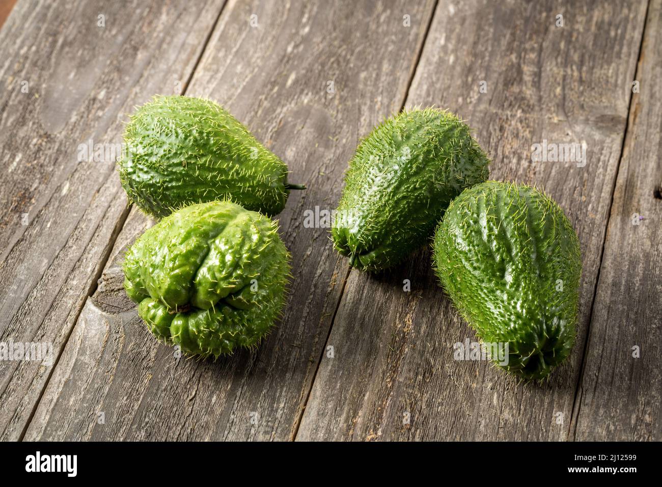 Prickly Chayote on wood background Stock Photo