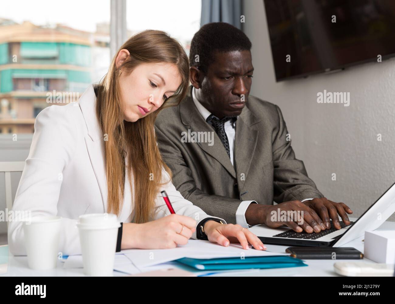 Focused coworkers working together Stock Photo - Alamy