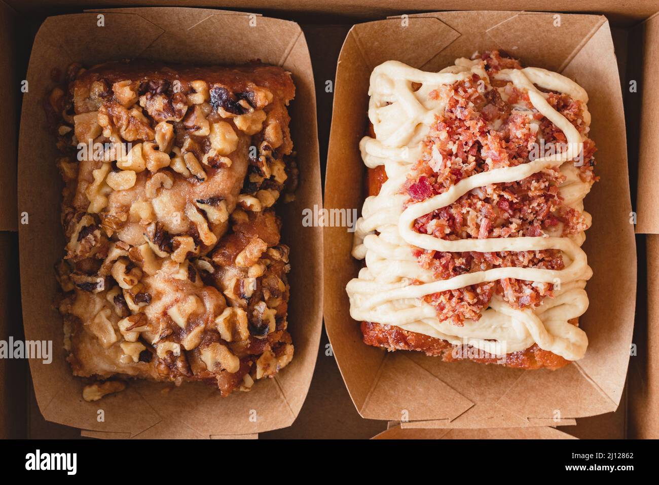Walnut cinnamon roll and maple bacon cinnamon roll close up, flat lay Stock Photo