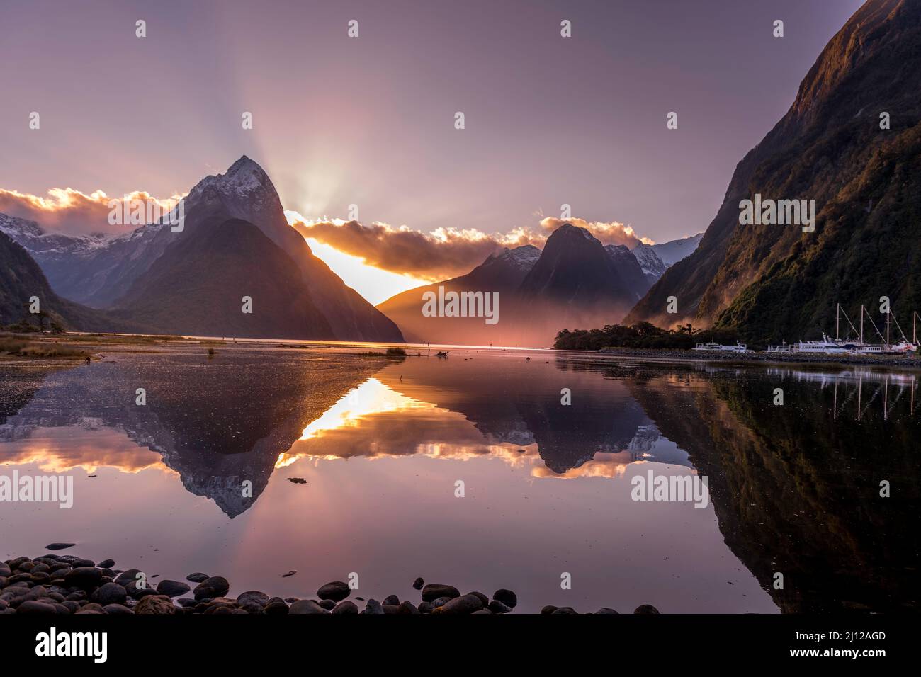 Golden Hour sunset reflections  Milford Sound New Zealand- winter capture with mitre peak Stock Photo