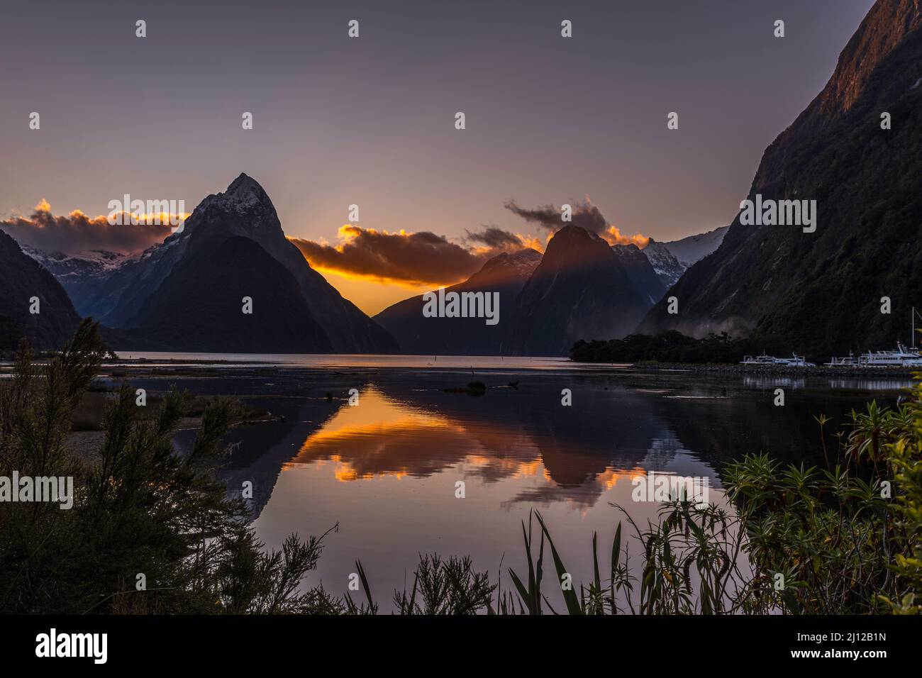 Golden Hour sunset reflections  Milford Sound New Zealand- winter capture with mitre peak Stock Photo