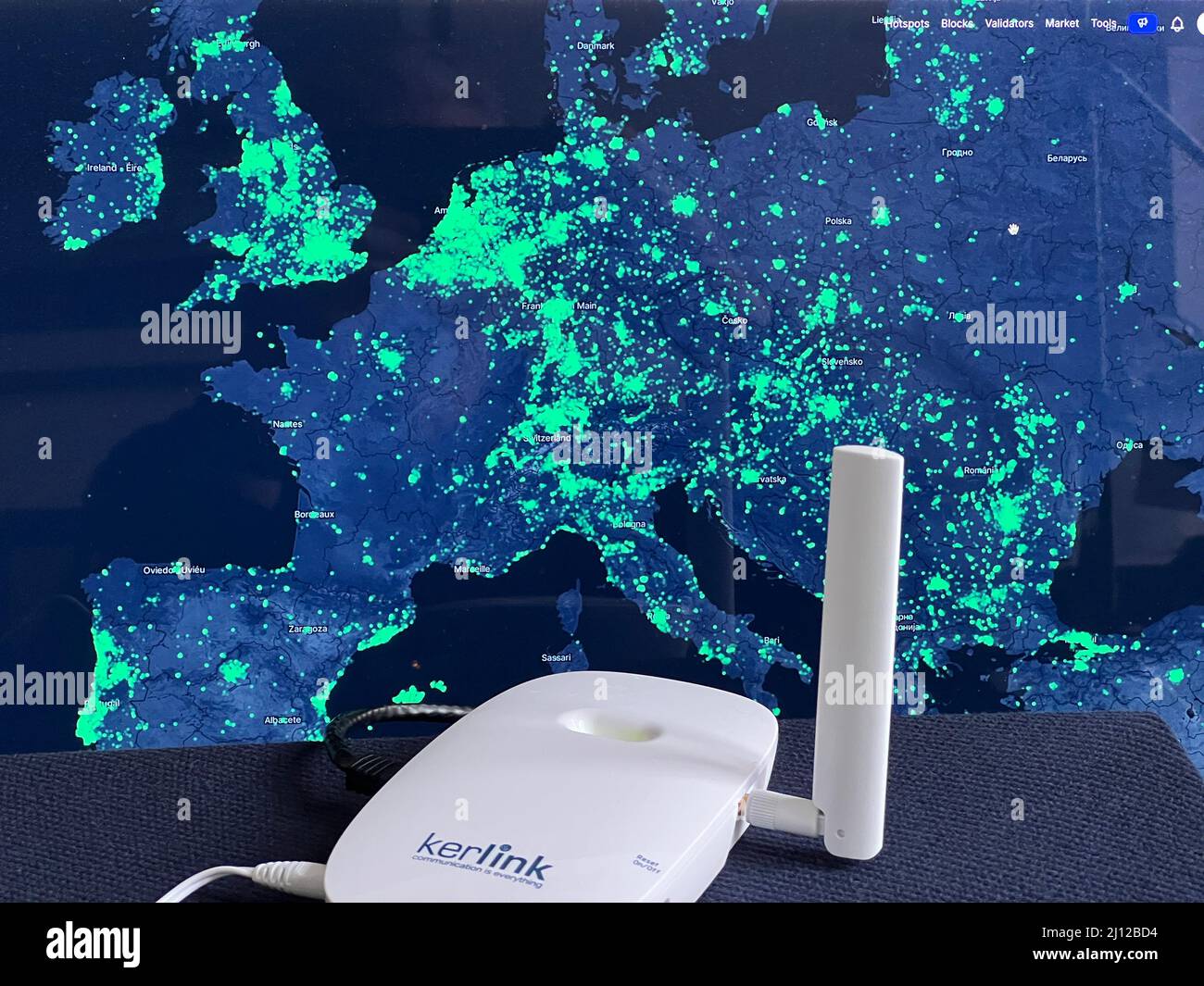 Berlin, Germany. 17th Mar, 2022. A radio hotspot of the Helium network in  front of a map of network coverage (Europe). Helium can be used to connect  devices such as e-scooters, smart