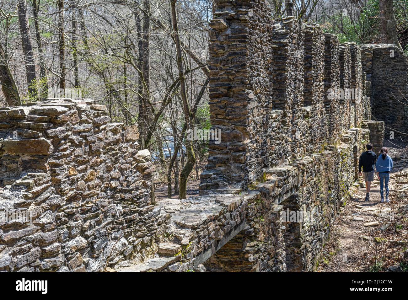 A young couple exploring the Sope Creek Mill Ruins, a part of the Chattahoochee River National Recreation Area, in Marietta, Georgia. (USA) Stock Photo