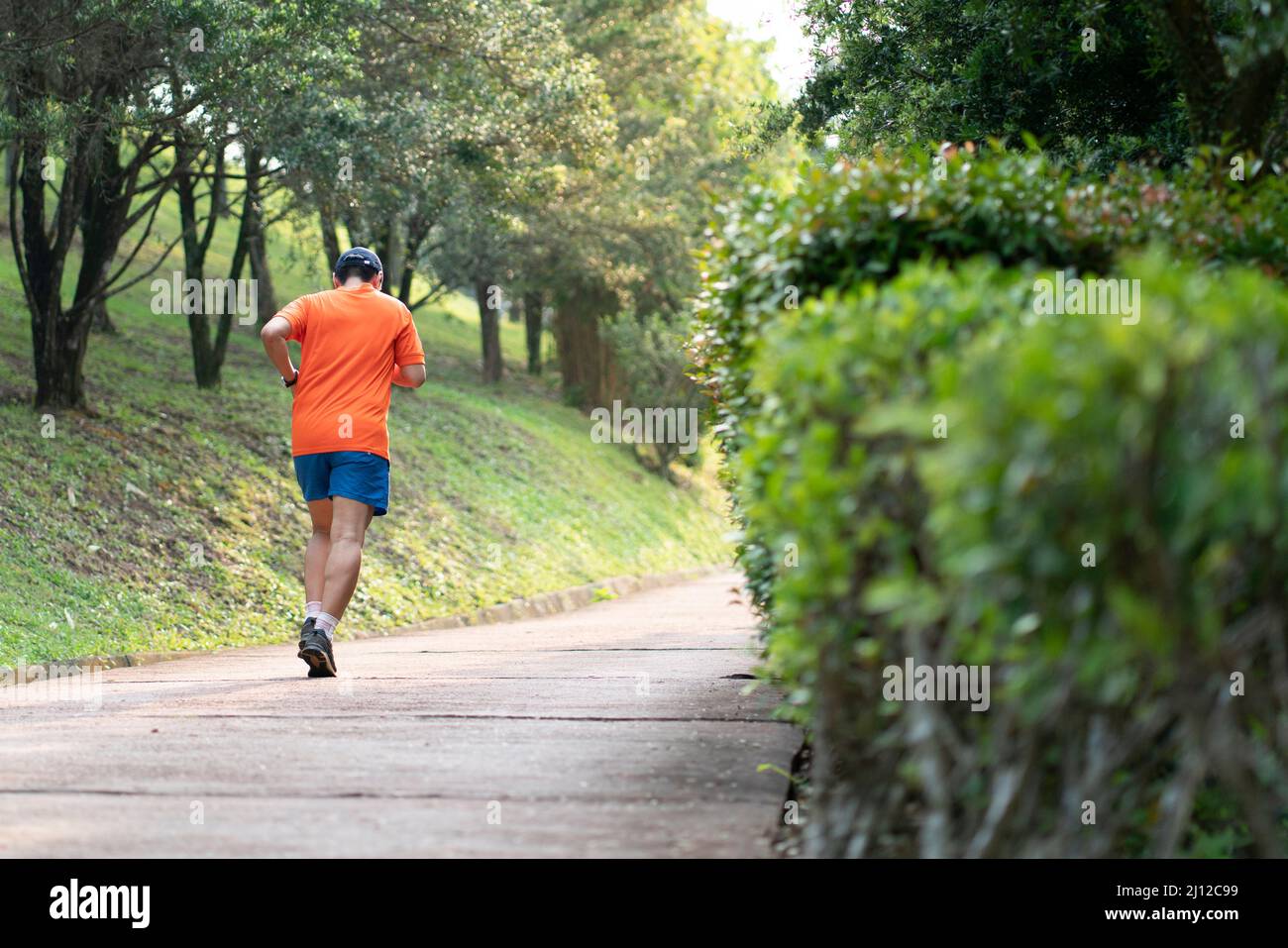 Man runner jogging on an outdoor path during sunset. Healthy lifestyle ...