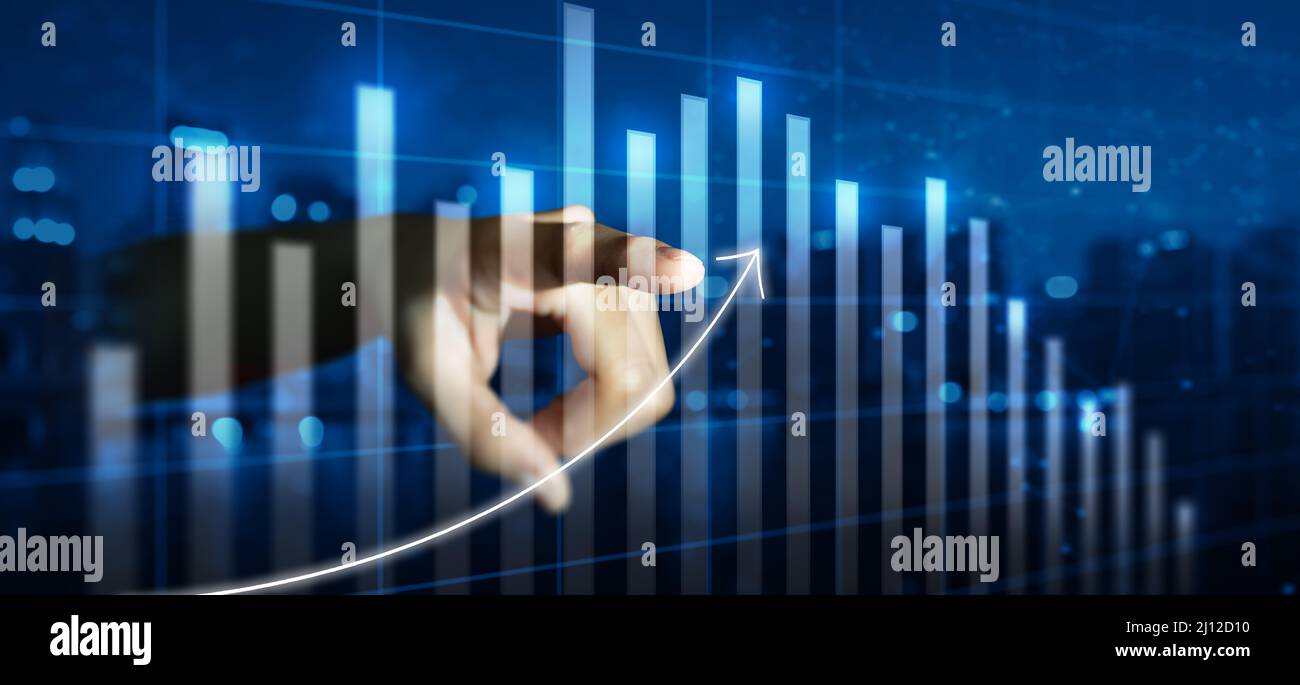 Double exposure of businessman hand pointing arrow graph and chart. Business growth and increase of positive indicator. Corporate business growth. Stock Photo