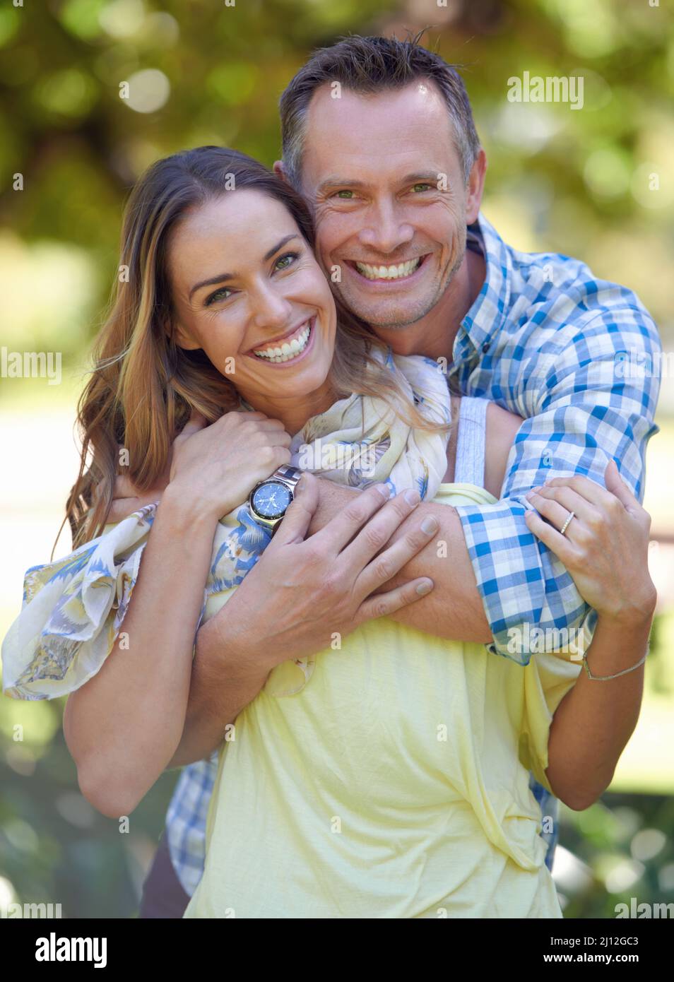 Shes my prisoner of love. Portrait of an affectionate couple outside in the summer sun. Stock Photo