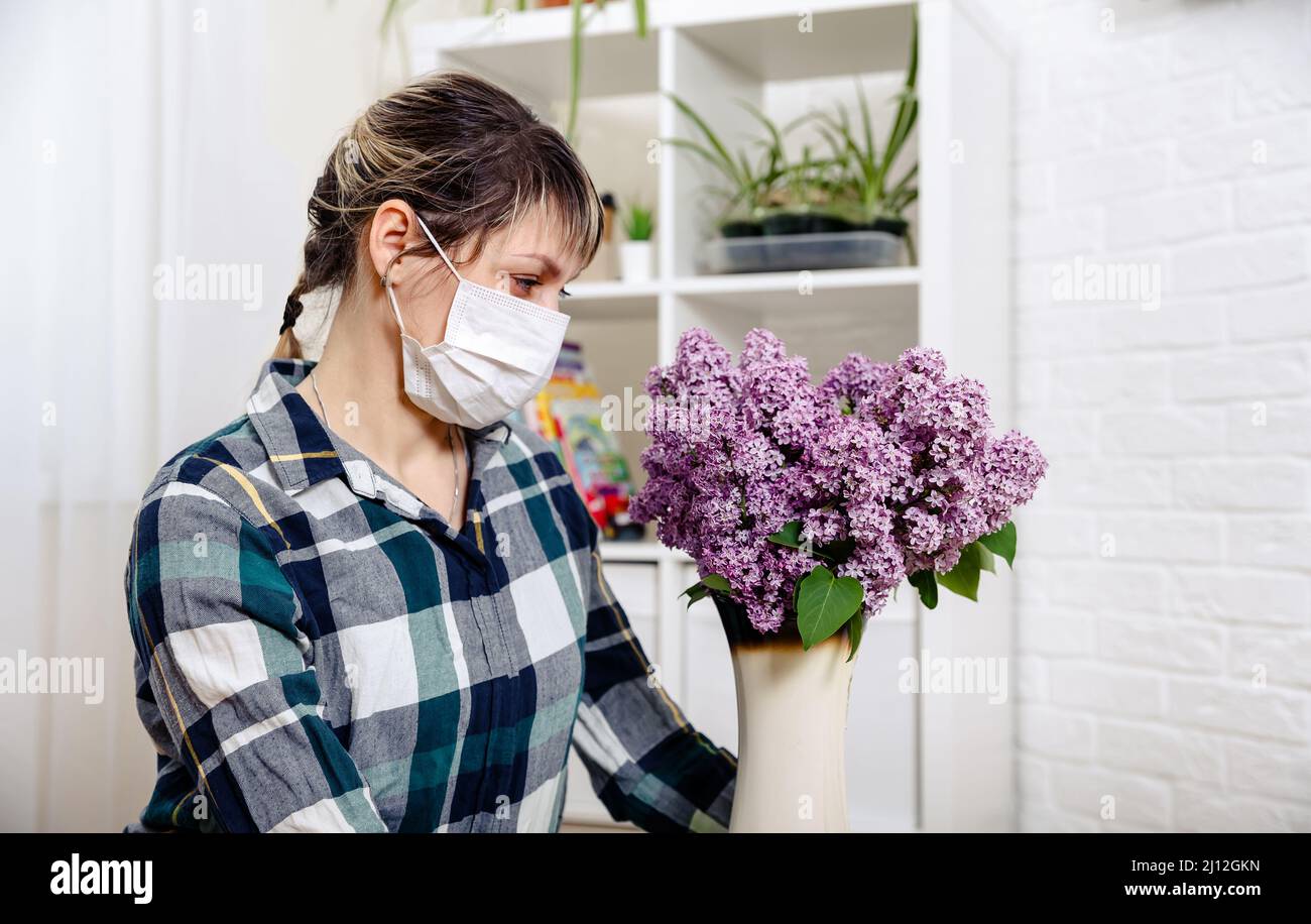 Girl in mask protects herself from an allergy to pollen from plants