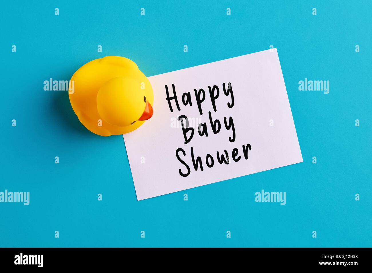 Happy baby shower message written on a note paper with a rubber toy