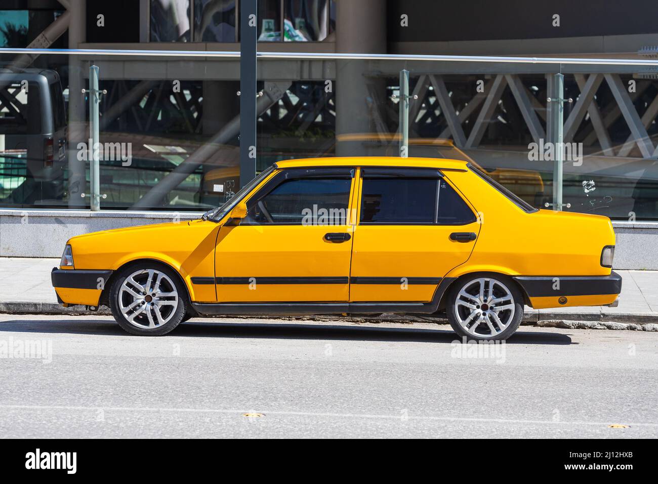 Antalya; Turkey – March 04 2022: yellow Tofas Dogan parked on the street on a warm summer day Stock Photo