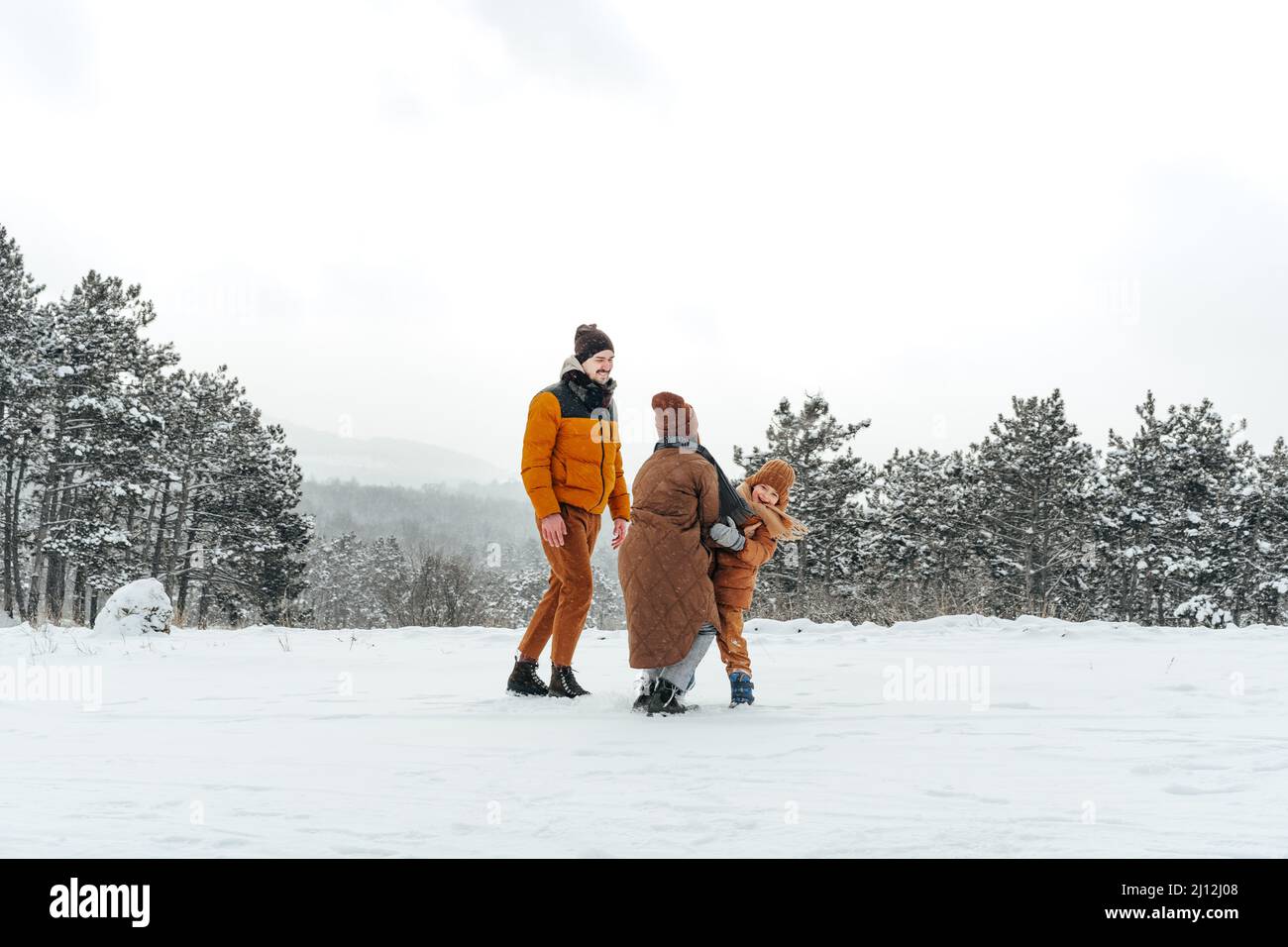 Happy family having a walk in winter outdoors in snow forest Stock ...