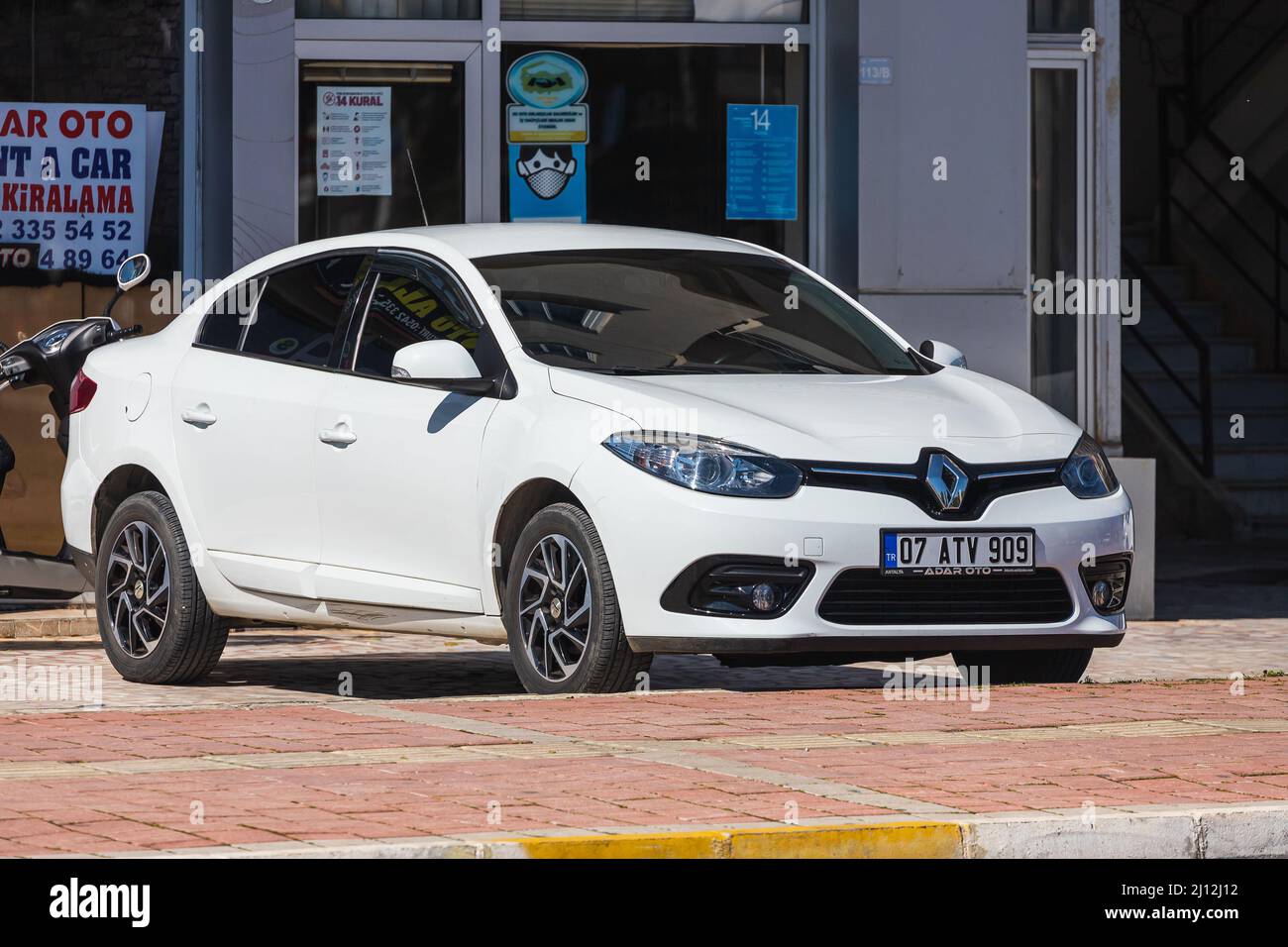 Antalya; Turkey – March 04 2022:   white Renault Fluence   is parked  on the street on a warm summer day Stock Photo