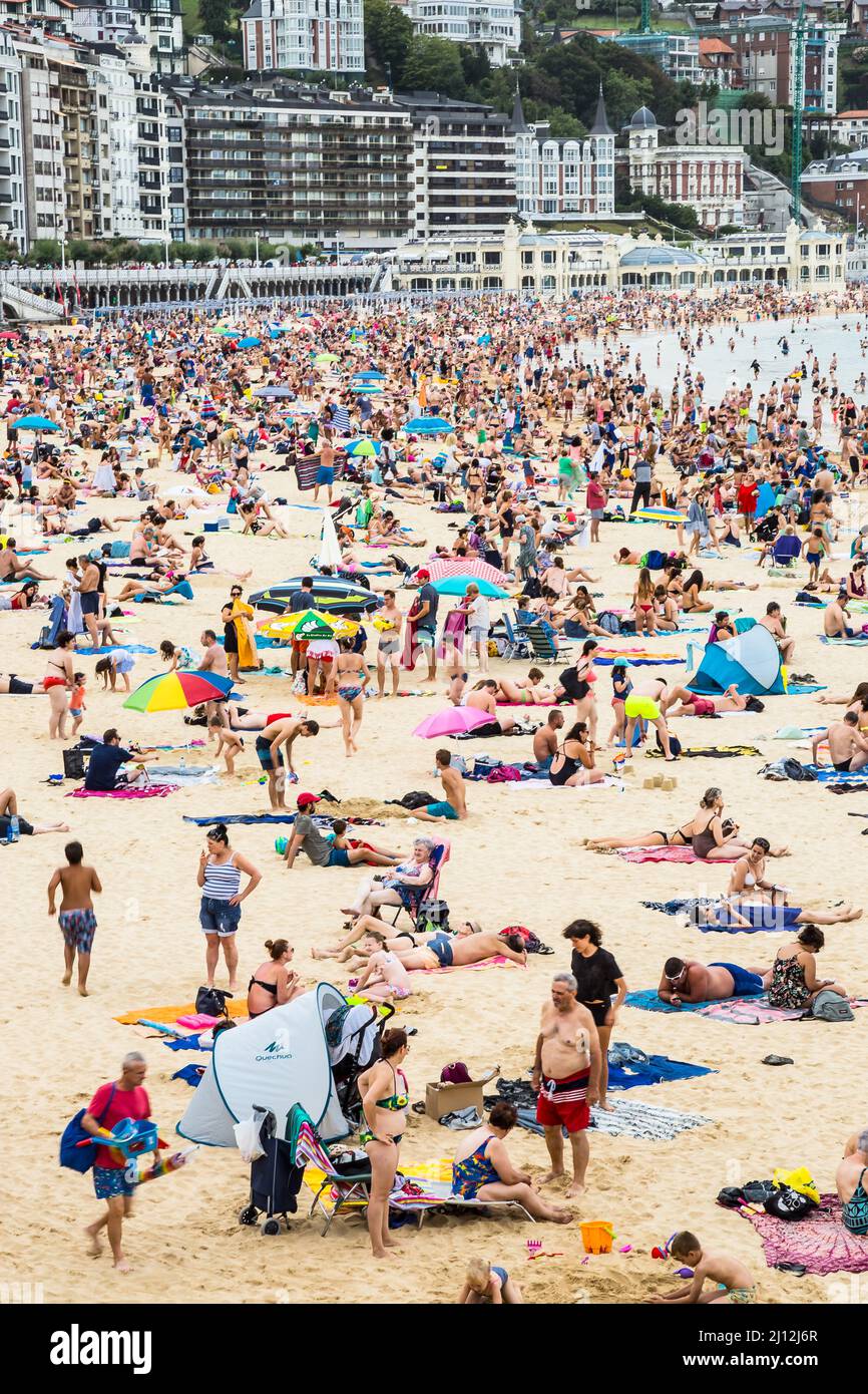 Summer time in San Sebastian crowded La Concha beach Donostia Basque country Northern Spain Europe Stock Photo