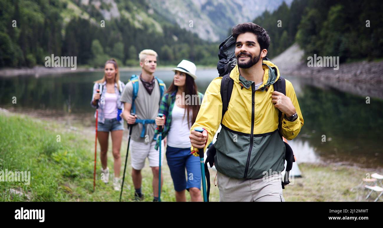 Group of young friends hiking in countryside. Multiracial happy people ...