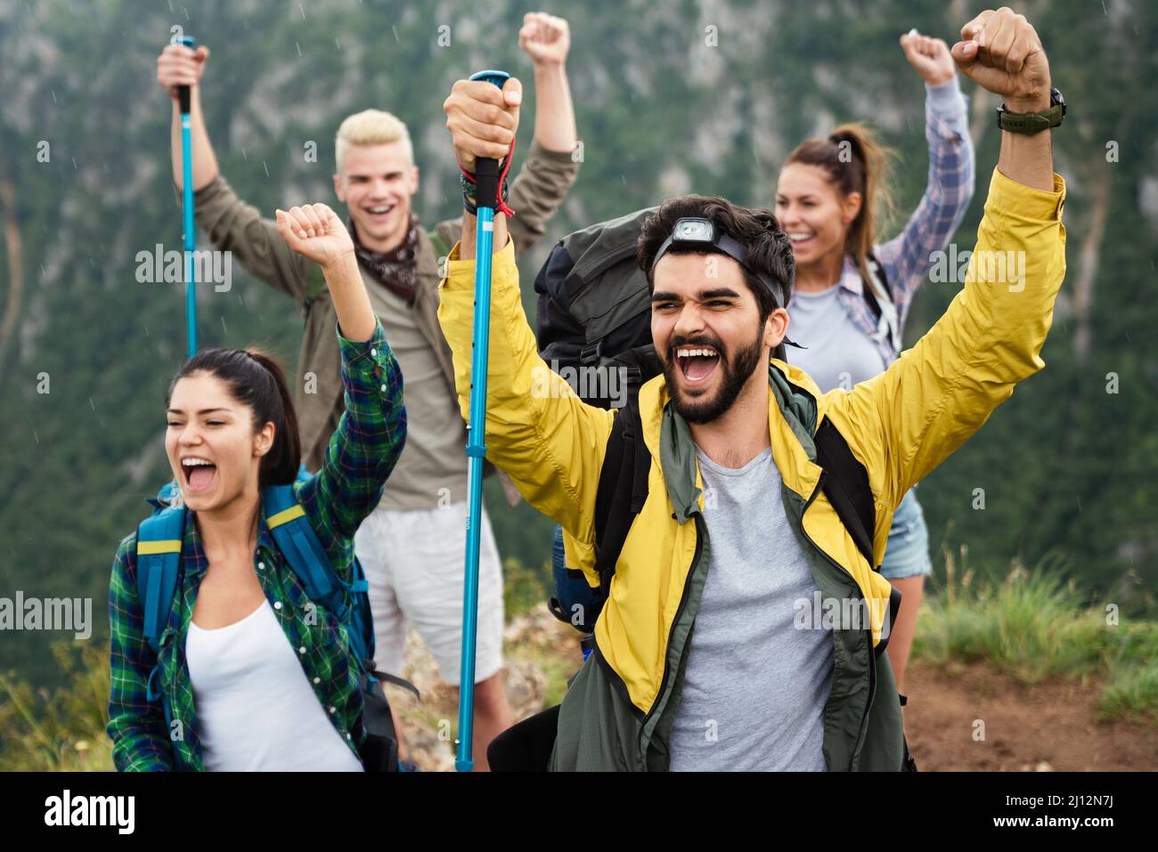 Group of young friends hiking in countryside. Multiracial happy people ...
