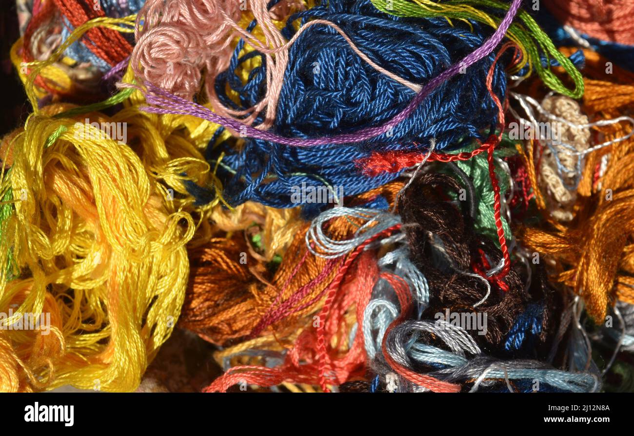 Close up view into a basket with colourful darning cotton. Stock Photo
