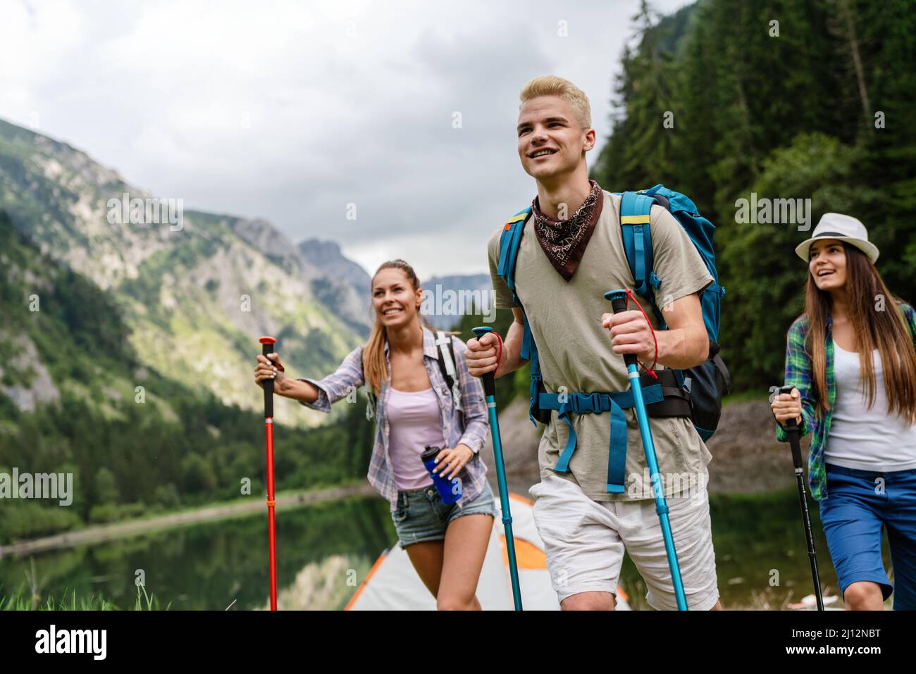 Hiking with friends is so fun. Group of young people with backpacks ...