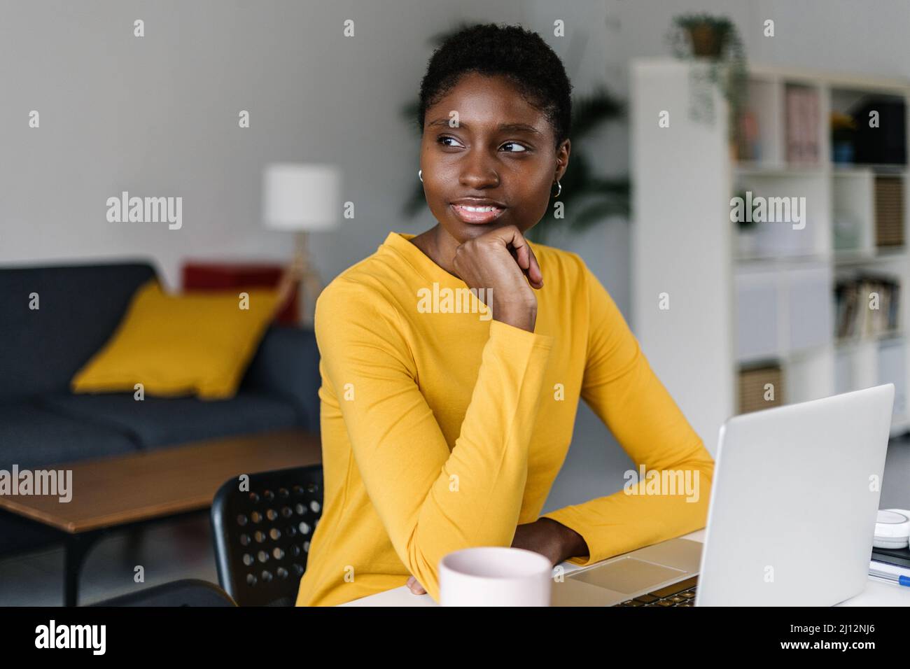 Thoughtful young black working from home Stock Photo