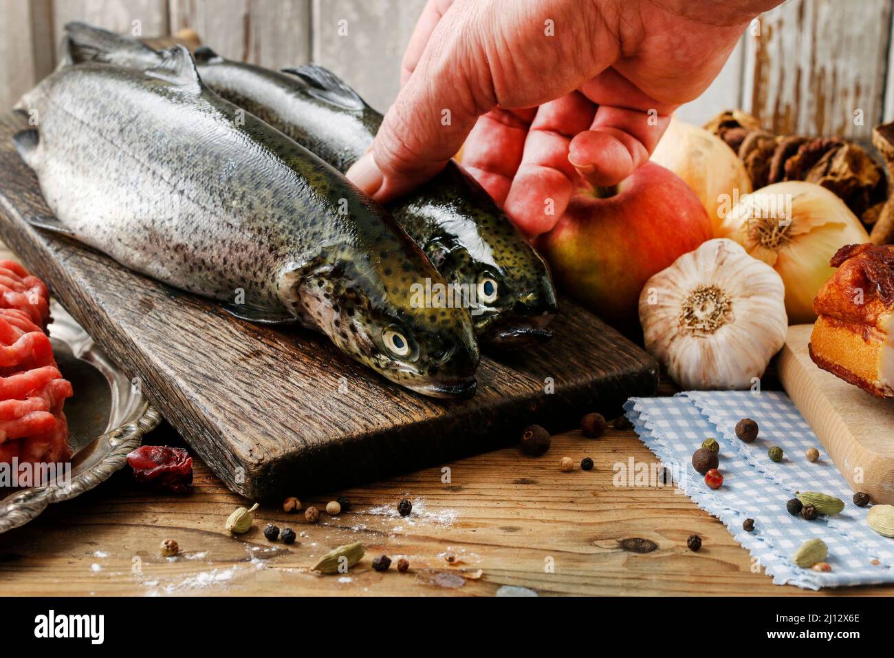 Cook holding a rainbow trout. Cooking time Stock Photo Alamy