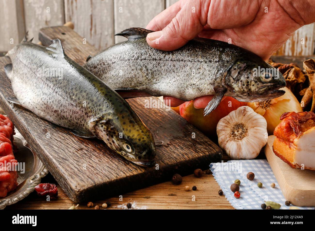 Cook holding a rainbow trout. Cooking time Stock Photo Alamy