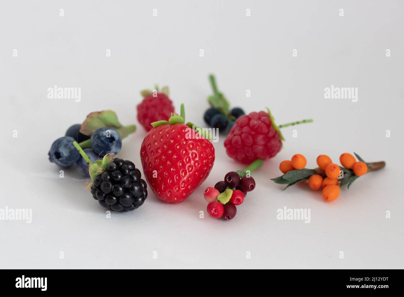 Miniature figures of strawberries, blackberries, raspberries, blueberries, blueberries, cranberries and cranberries Stock Photo