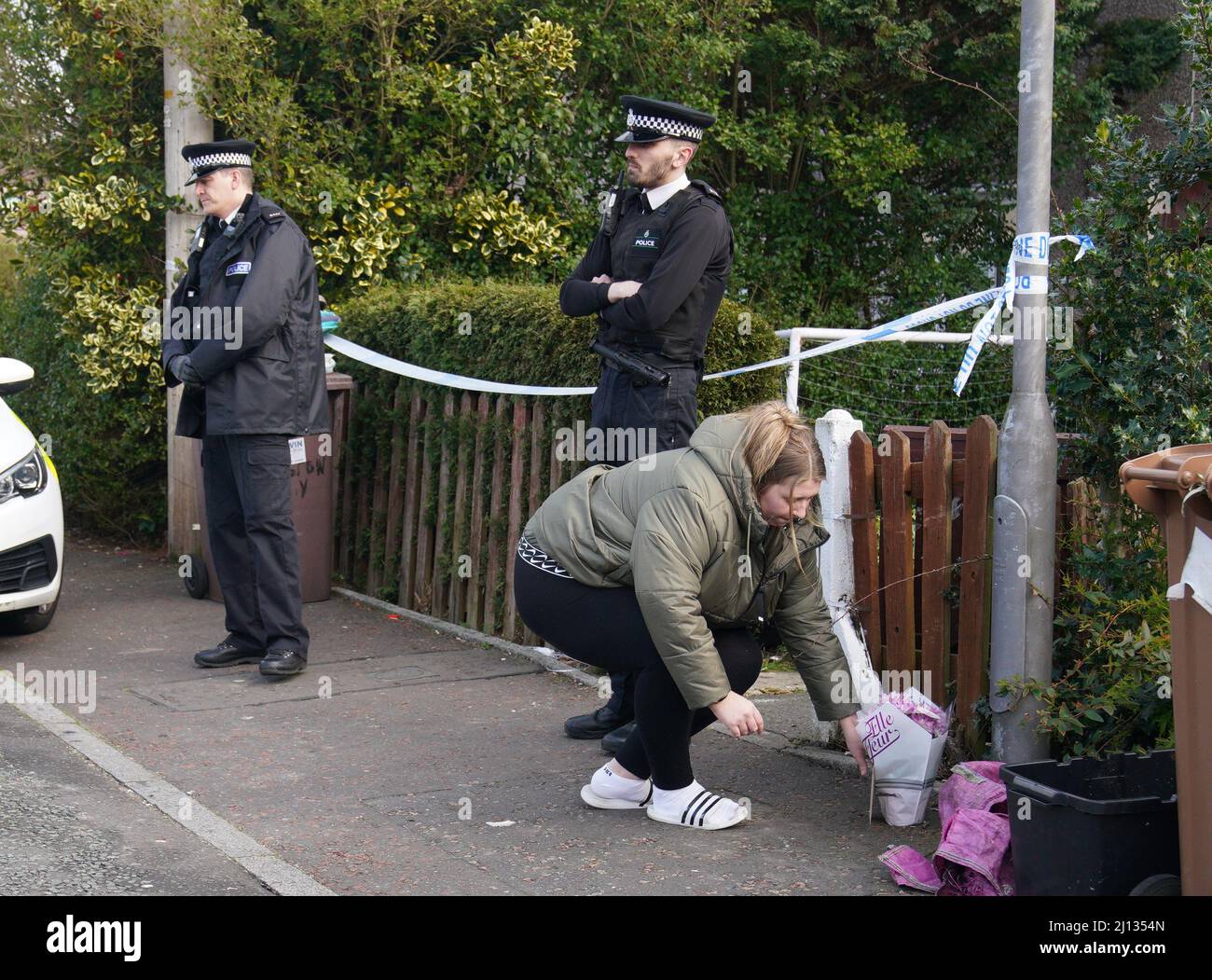 A woman lays flowers at a house in St Helens after a 17-month-old girl ...