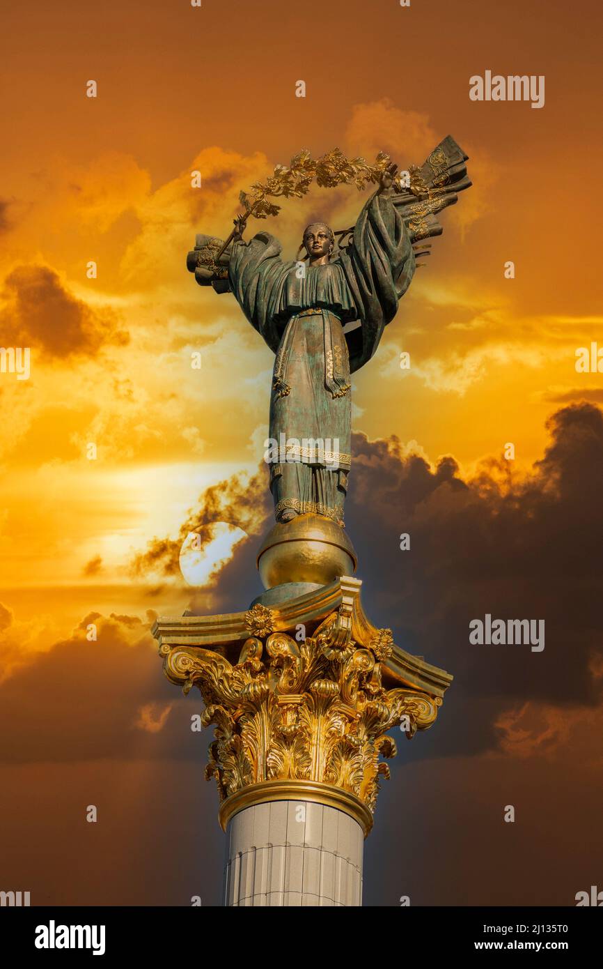 Independence monument on golden sky with clouds background in Kyiv