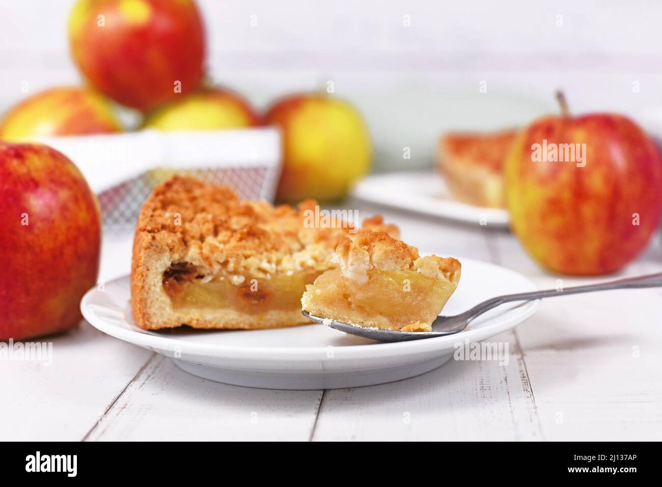 Piece of traditional European apple pie with topping crumbles called 'Streusel' on dessert spoon Stock Photo