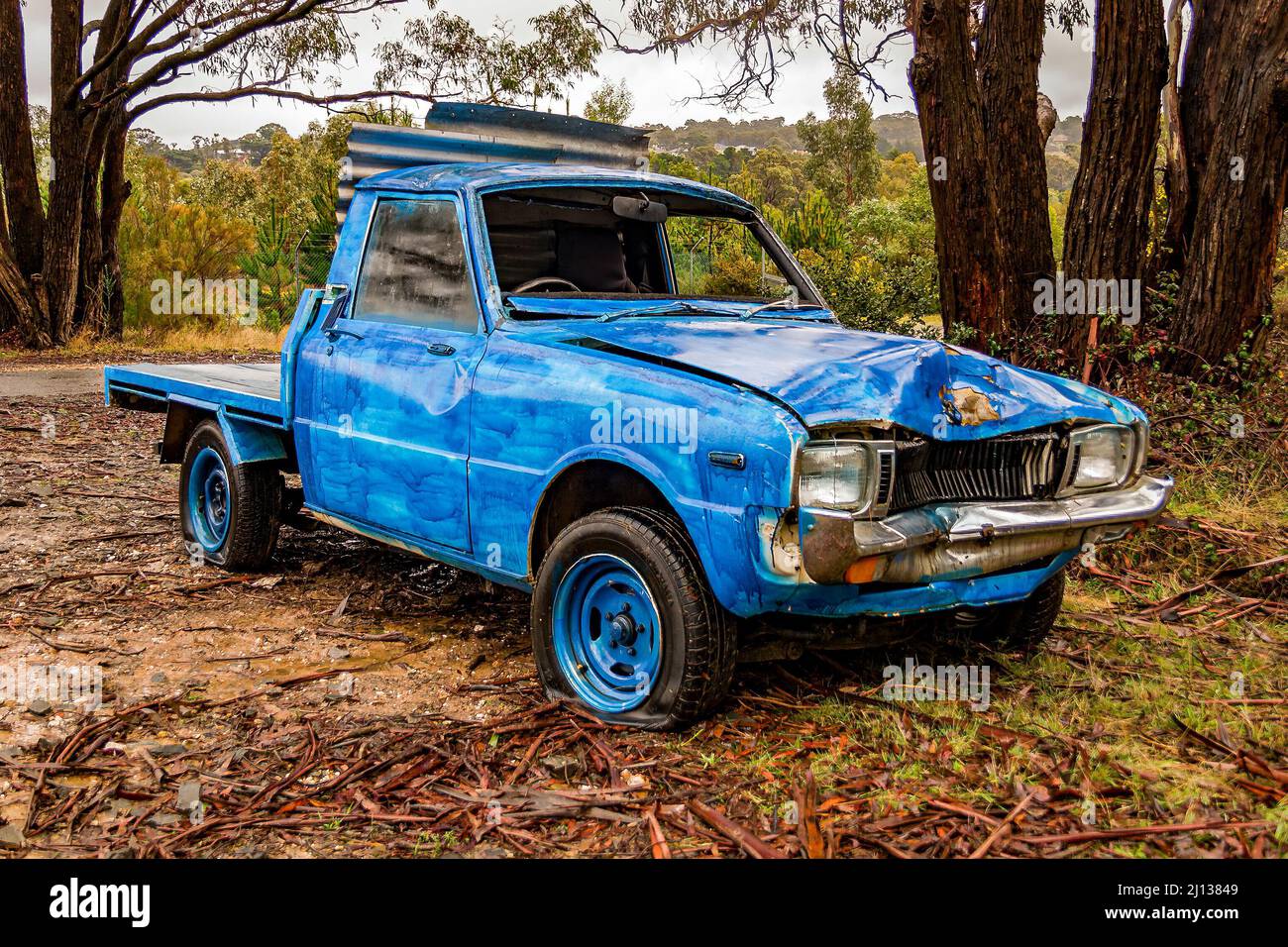 Abandoned blue vintage utility truck decaying with time Stock Photo