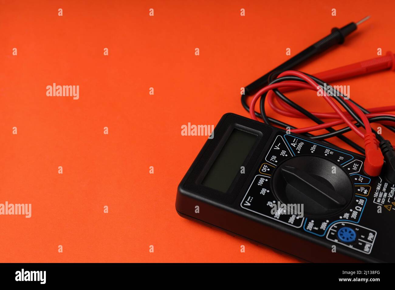 Multimeter on orange background, space for text Stock Photo