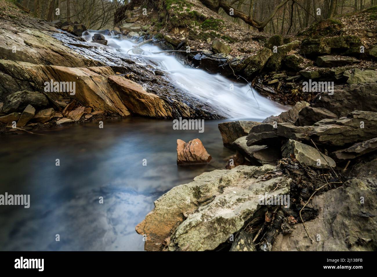 River Surrounded By Rocks Natural landscape of a river stream surrounded by rocks Stock Photo - Alamy