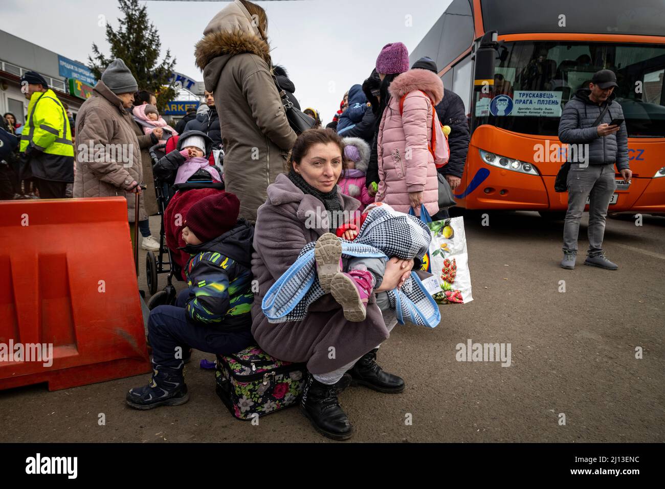 Arrival of refugees from Ukraine on the Ukrainian side of the border crossing in Shehyni. Here the refugees wait, in long queues, for clearance by Ukrainian border officials. After entering Poland, they are provided with hot food and clothing, and then transferred by bus to large sites or collective shelters. Stock Photo
