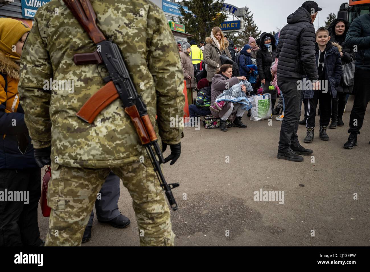 Arrival of refugees from Ukraine on the Ukrainian side of the border crossing in Shehyni. Here the refugees wait, in long queues, for clearance by Ukrainian border officials. After entering Poland, they are provided with hot food and clothing, and then transferred by bus to large sites or collective shelters. Stock Photo
