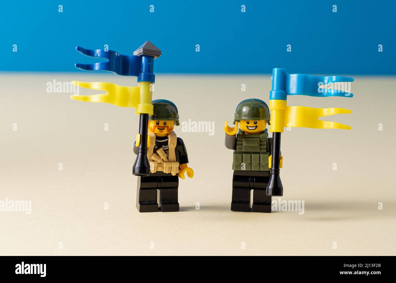 Lego little men with flags of Ukraine. A minifigure toy man holding a blue flag. Soldiers mini figure. Support of the Ukrainian people. Ukraine, Kyiv - March 20, 2022. Stock Photo