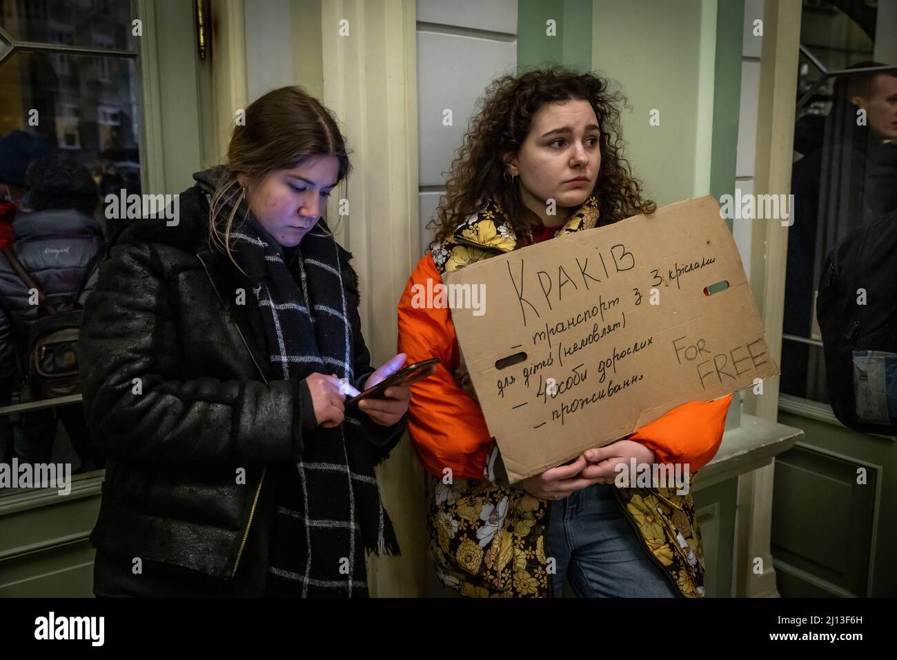 Volunteer offers rides and accommodation with his cardboard sign at the train station in Przemysl, Poland, not far from the Polish-Ukrainian border. Here the refugees are provided with warm food and clothing. From here they are forwarded to large-scale or collective accommodation. Stock Photo