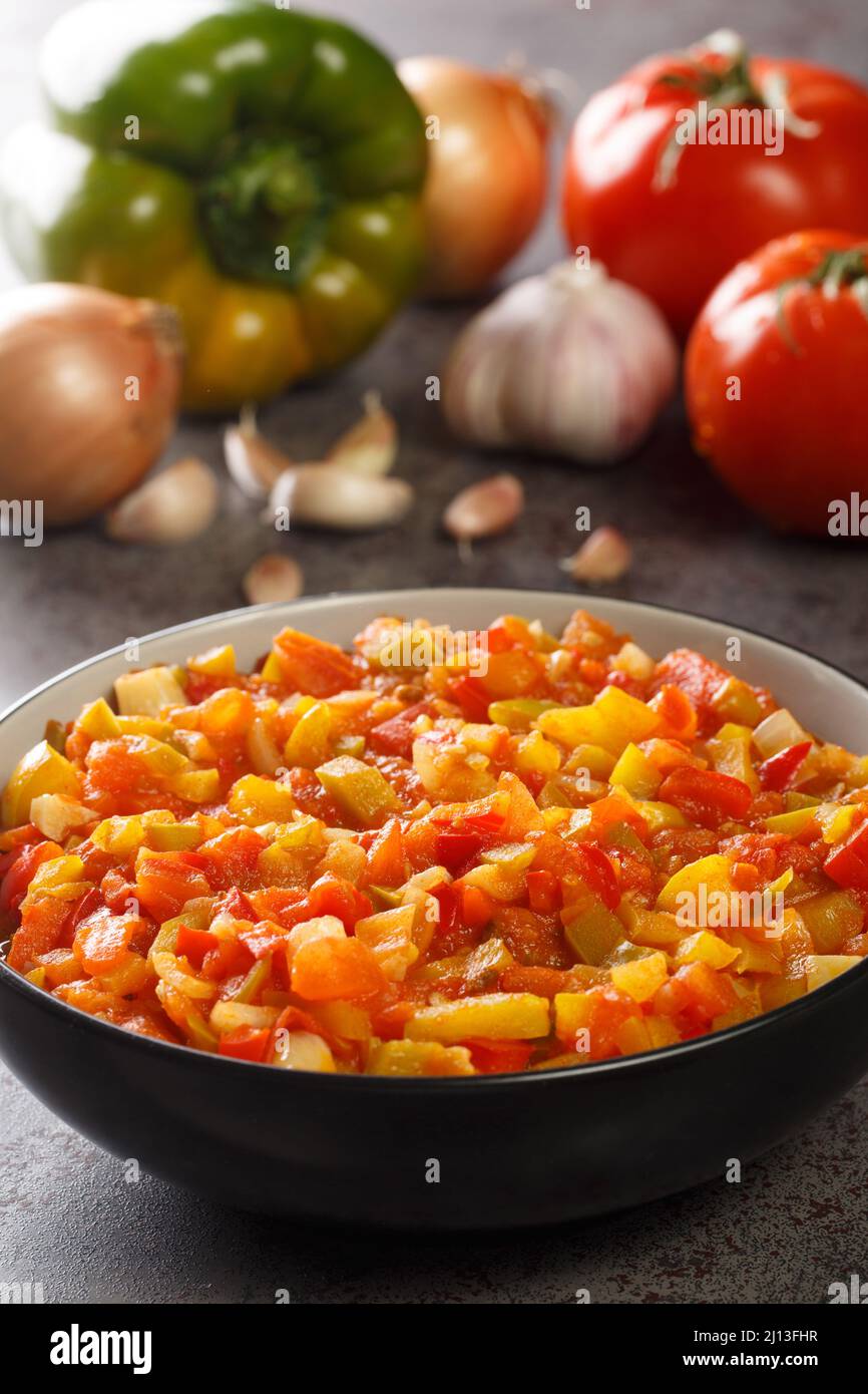 Sofrito is a basic sauce of green pepper, onion, tomato, garlic, and other seasonings closeup in