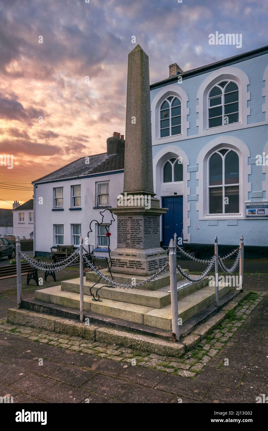 The Grade II listed War Memorial is a plain obelisk on a square plinth, inscribed with the names of the fallen from both wars. It can be found outside Stock Photo