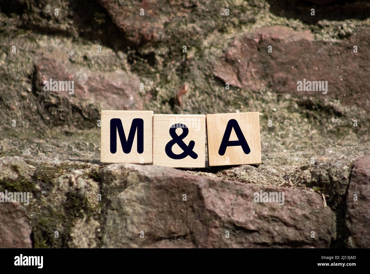 Close-up Of King Chess Pieces On Wooden Blocks With Mergers And Acquisitions. Stock Photo