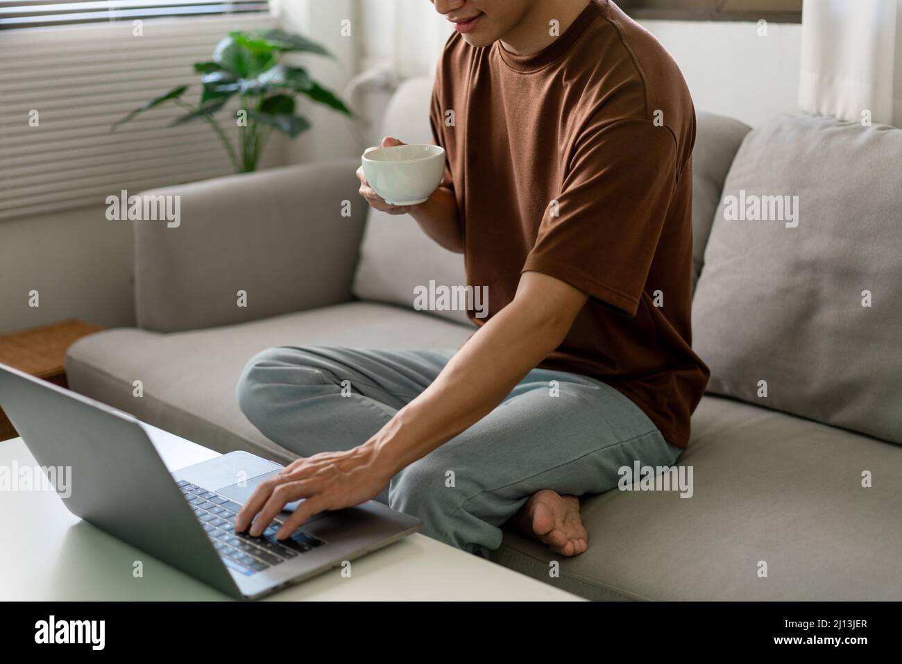 Technology Concept The man in brown T-shirt using one hand typing on ...