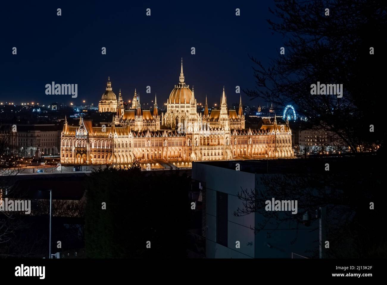 unuque wiev about the Hungarian parliament's building. St Stephen basilica tower on the background and budapest eye ferris wheel on the right side Stock Photo