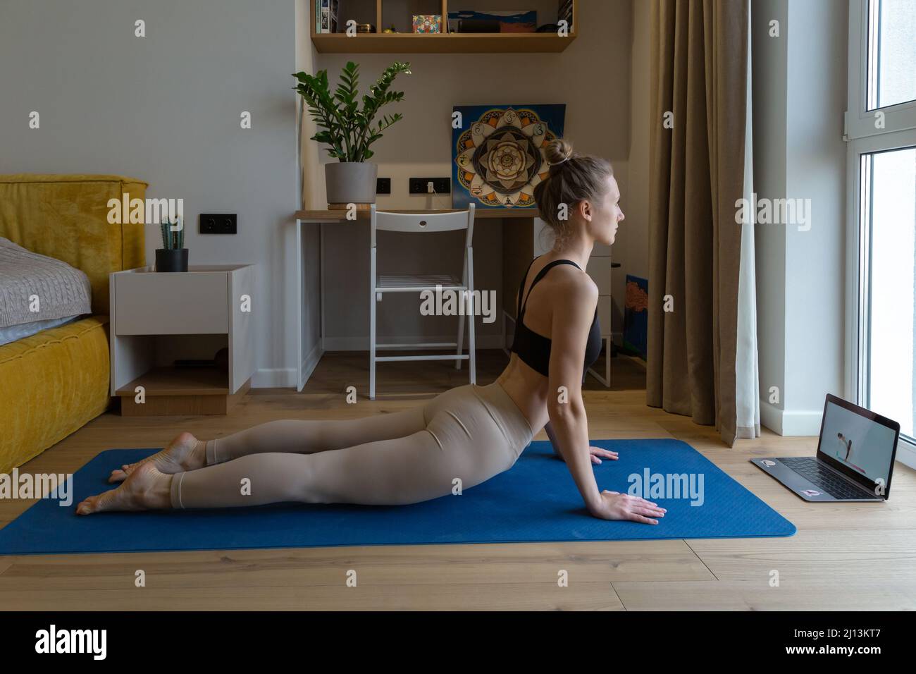 woman is having online yoga class Stock Photo