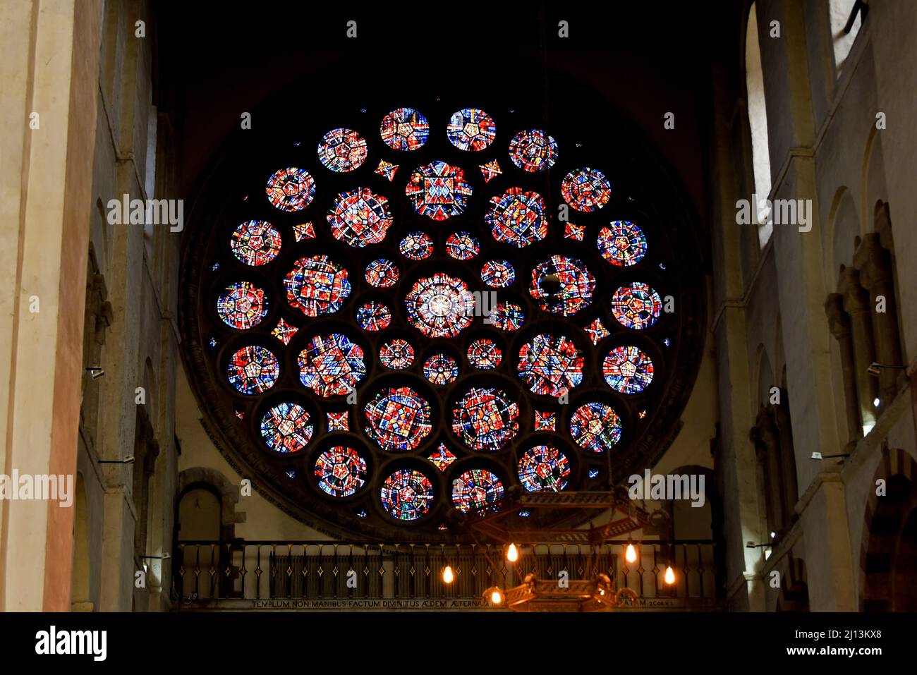 Stained glass window in a church is round with intricate circular detail Stock Photo