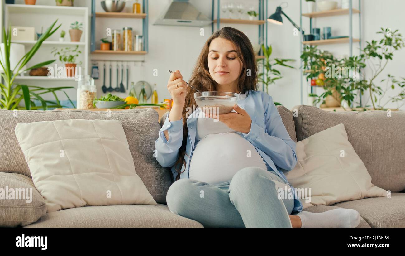 Beautiful Pregnant Woman Eating Healthy Breakfast Muesli With Nuts on