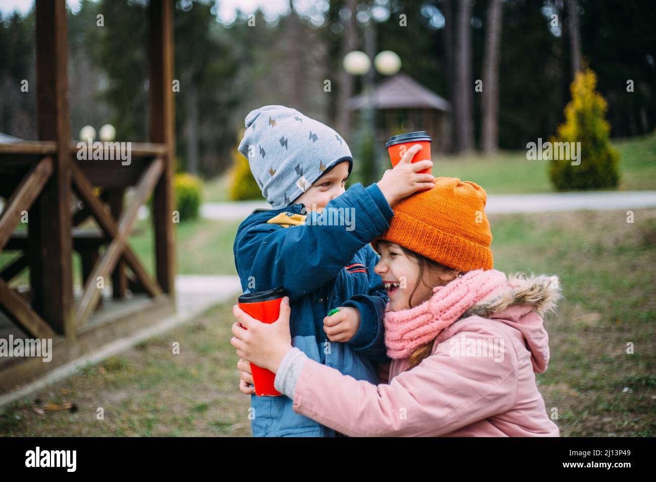 Brother and sister have fun and laugh outside in autumn in the park ...