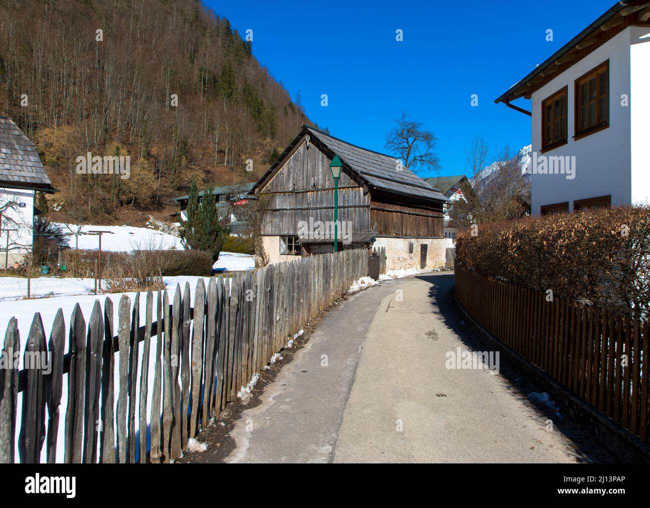 Colorful picturesque city street with traditonal houses in mountain village Hallstat near lake and Alps. UNESCO heritage. Upper Austria, Europe Stock Photo