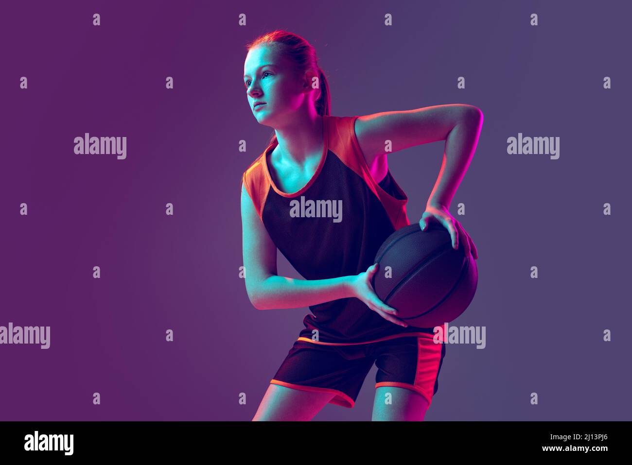 Portrait of young sportive girl, basketball player training, preparing