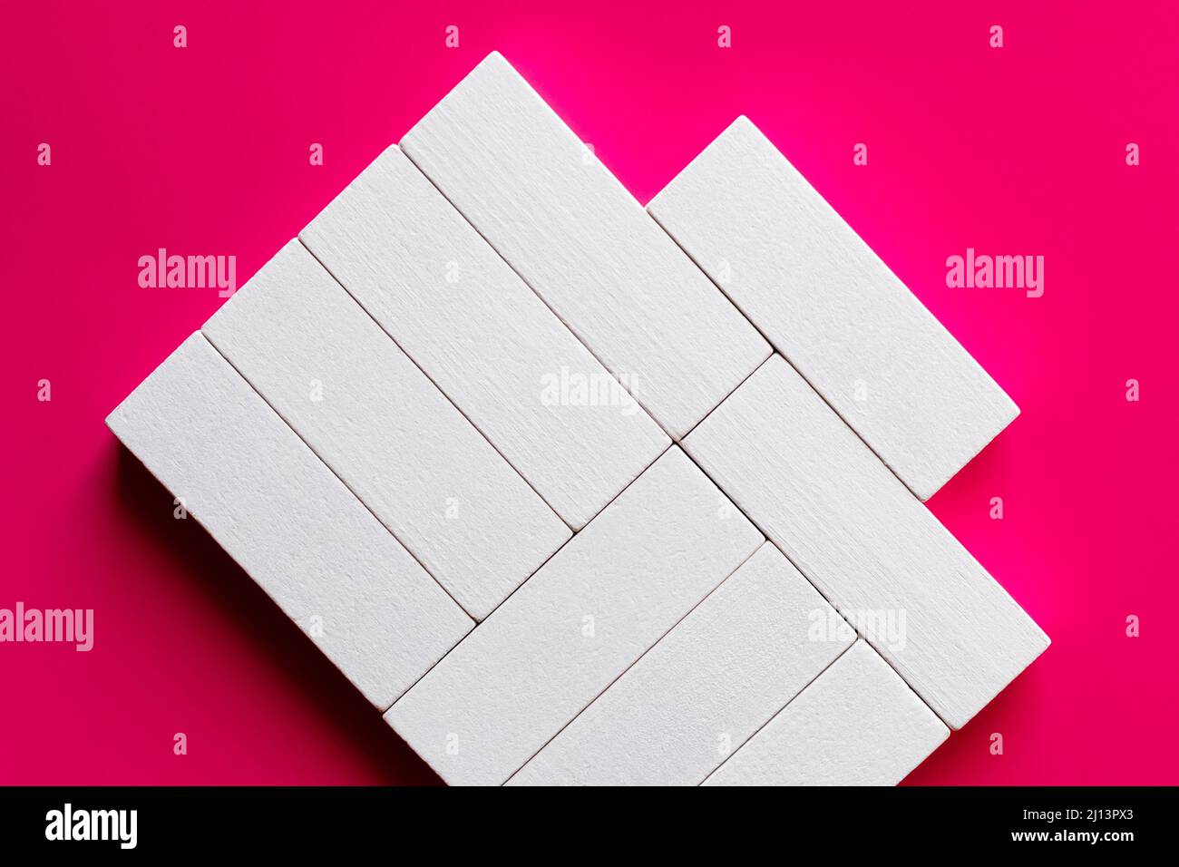 top view of white rectangular shape blocks on pink background Stock Photo