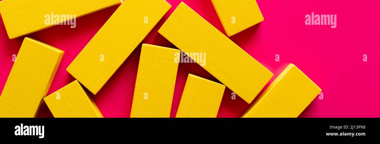 Yellow Rectangular Blocks top view of yellow rectangular blocks on pink background, banner Stock ...